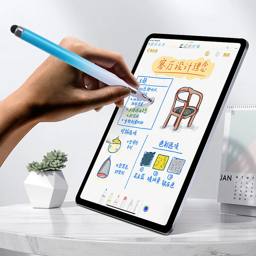A hand holds a blue stylus pen writing on an iPad screen displaying a color design plan.