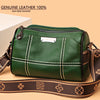 A dark green genuine leather shoulder bag with brown trim and strap, shown in a studio setting.