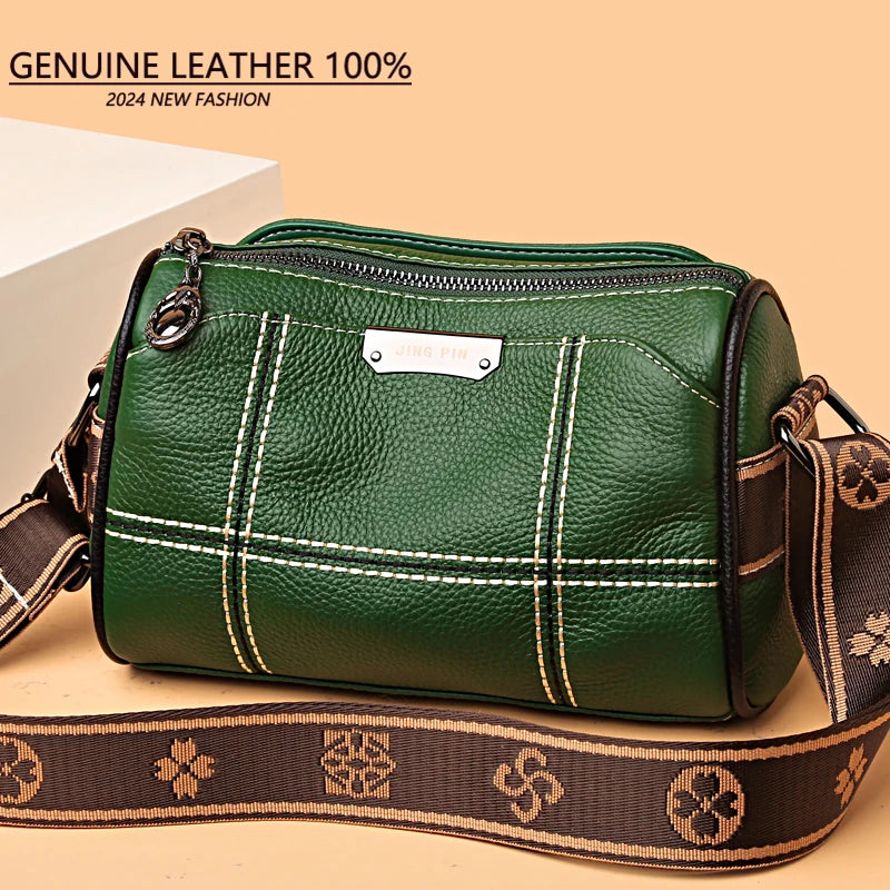 A dark green genuine leather shoulder bag with brown trim and strap, shown in a studio setting.