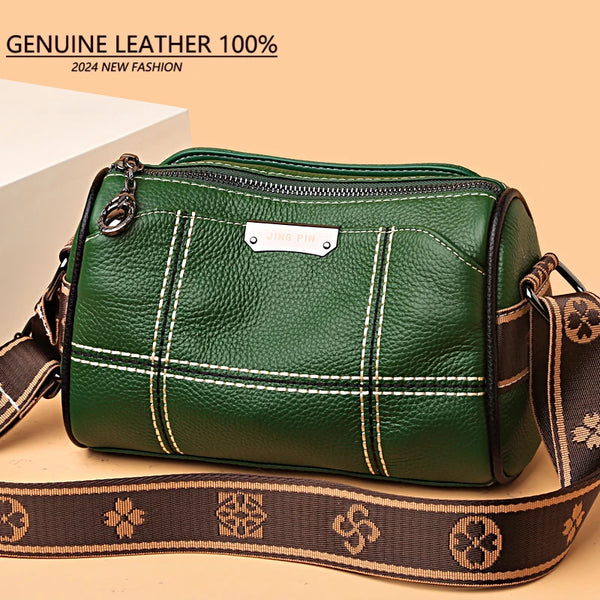 A dark green genuine leather shoulder bag with brown trim and strap, shown in a studio setting.