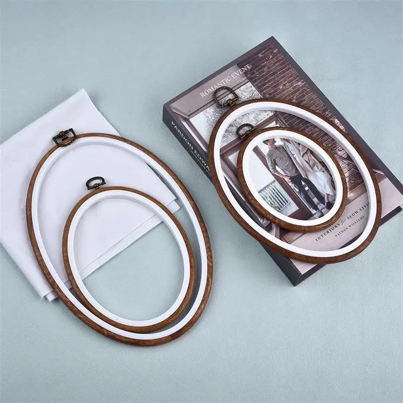 A set of wooden embroidery hoops for cross-stitch and needlework displayed next to a box.