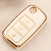 A white TPU silicone car key case with gold accents and a circular opening for keys.