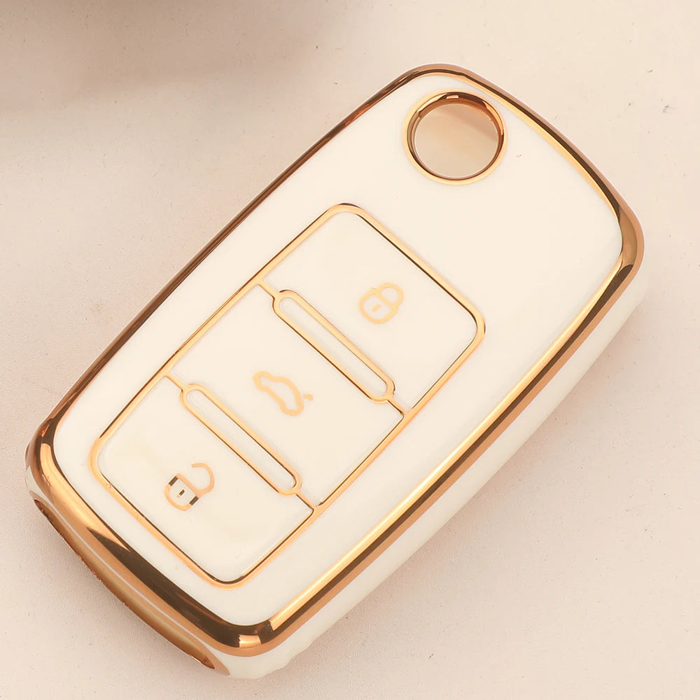 A white TPU silicone car key case with gold accents and a circular opening for keys.