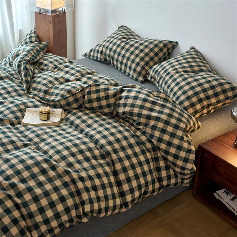 A plaid duvet cover in olive green and beige tones with a checkered pattern displayed on a bed.