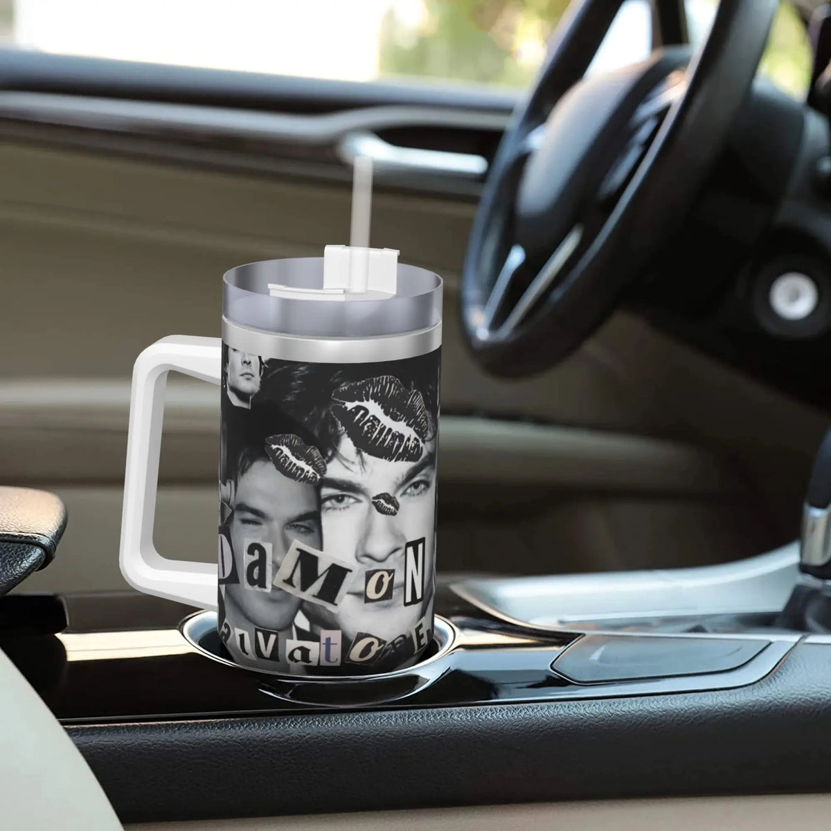 A silver insulated stainless steel tumbler with a straw lid featuring a close-up portrait of a man.