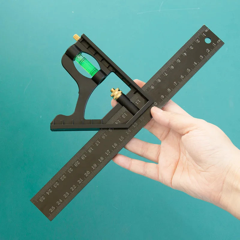 A hand holds a black multifunctional carpenter square with an angle level and protractor, showing its measurement markings.
