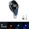 A close-up view of a crystal gear lever with seven different colored LED illumination options.