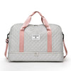 A light gray nylon travel duffle bag with pink straps and a square logo tag.