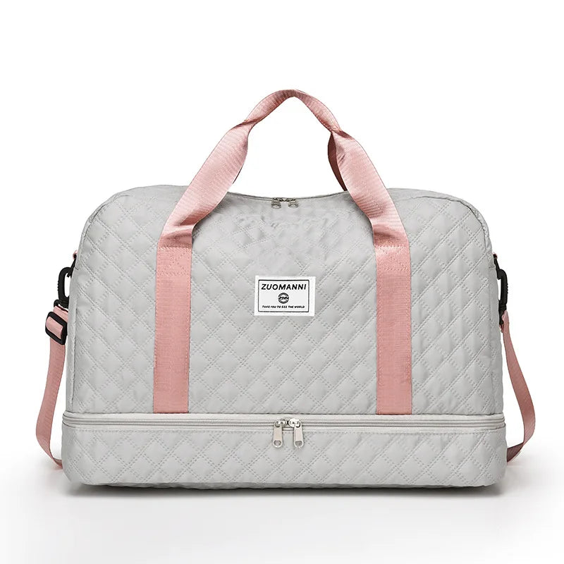 A light gray nylon travel duffle bag with pink straps and a square logo tag.