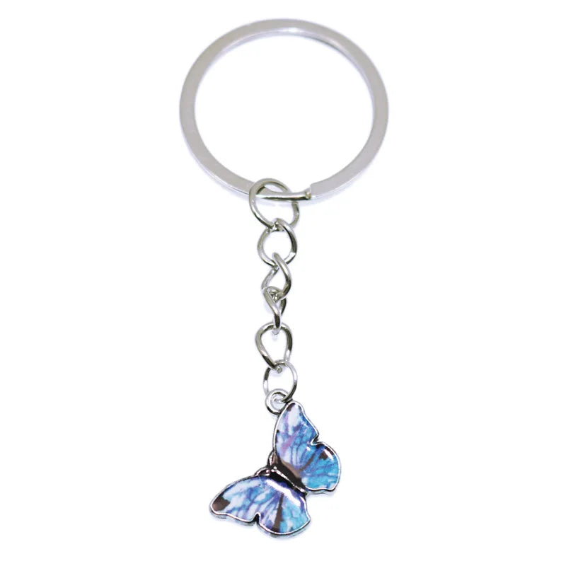 A silver hoop keychain charm featuring a colorful butterfly.