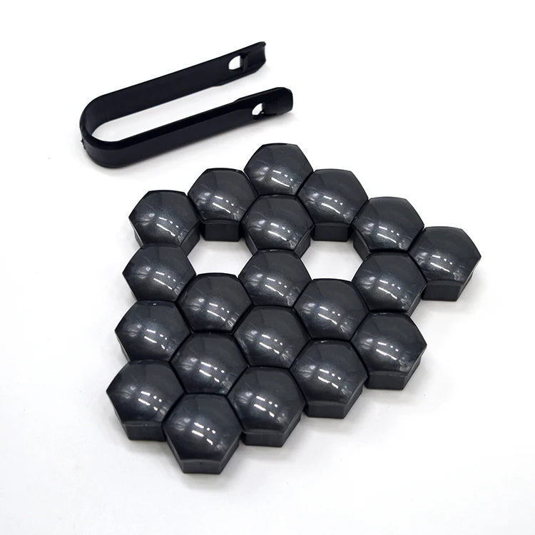 A set of 20 black hexagonal car wheel nut cap covers and a corresponding tool.