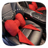 A red butterfly bow tie neck pillow with a matching cotton and linen cover shown in a car seat interior.