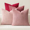 Three textured throw pillows in shades of pink and coral corduroy fabric