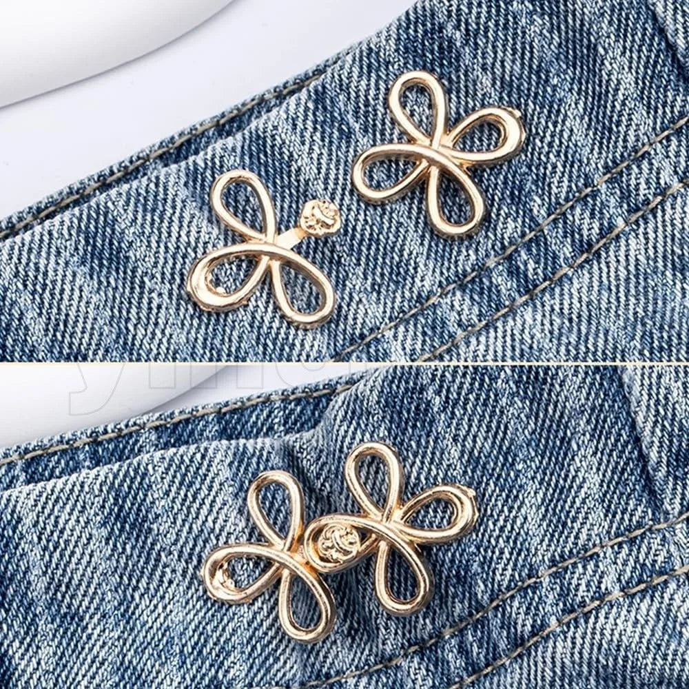 Gold clover-shaped adjustable buckle attached to denim fabric