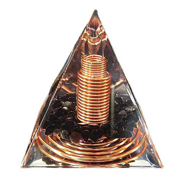 A clear pyramid-shaped ornament featuring a spiral copper wire coil inside.