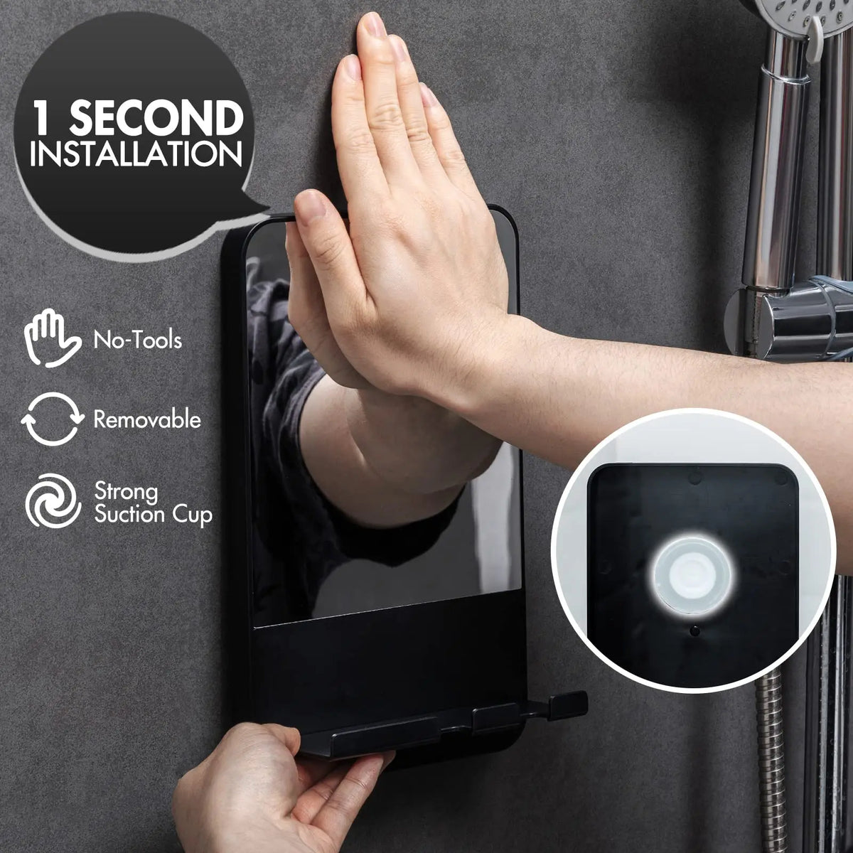 A hand is installing a fogless shower mirror with a razor holder onto a dark gray wall surface.