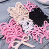 Assortment of pink, white, and black curly bow iron-on patches for DIY clothing decoration