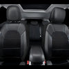 Interior view of a car with black PU leather seat covers and breathable mesh accents.