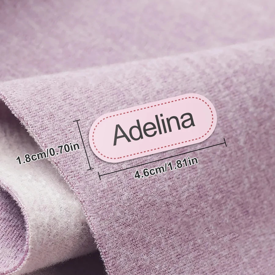 Tela de punto rosa con una etiqueta que muestra el nombre Adelina y sus dimensiones.
