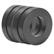 A stack of industrial-grade ceramic ring magnets, dark gray in color.