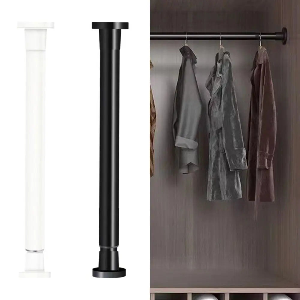 A black adjustable steel tension curtain rod with hanging clips mounted on a wall.