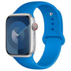 A blue silicone sport band worn around an Apple Watch.