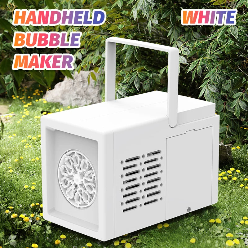 A white handheld bubble maker device is shown outdoors on green grass with foliage in the background.