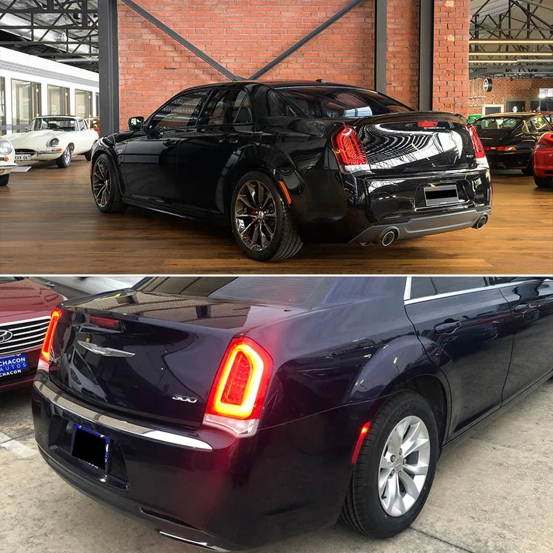 A black Chrysler 300 sedan with aftermarket rear bumper reflector light covers displayed indoors.