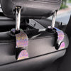 A close-up of a car seat storage hook set featuring crystal diamond accents on black leather upholstery.