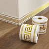 Roll of gold and white self-adhesive PVC trim for baseboards and door frames