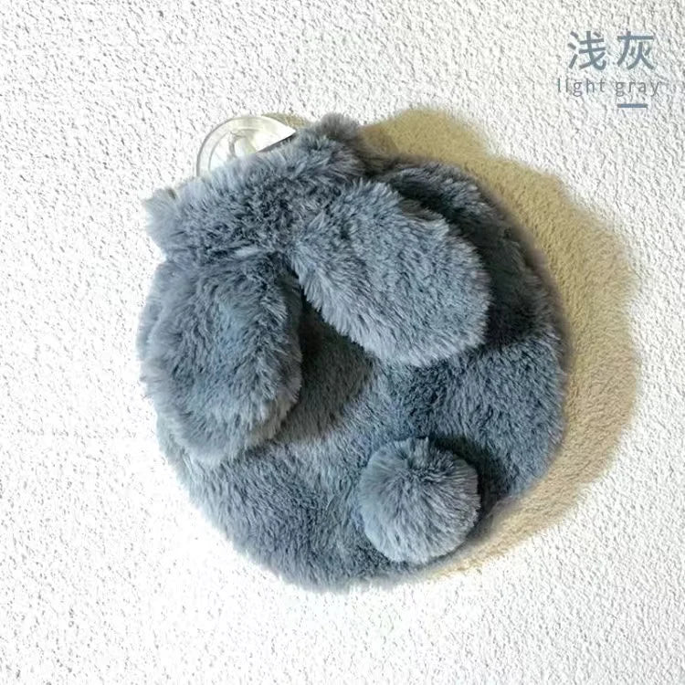 A gray plush rabbit hot water bottle with a soft flannel cover.