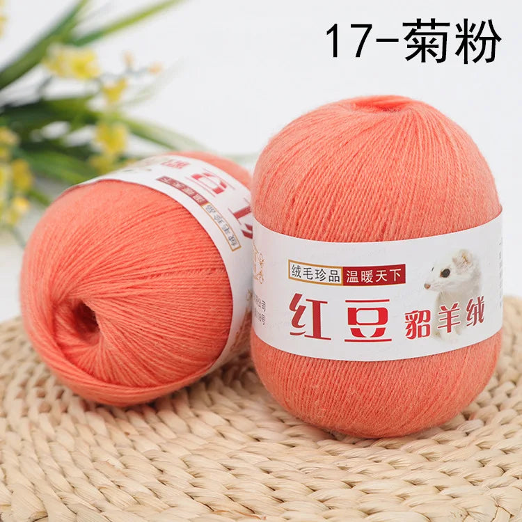 A ball of bright coral orange yarn labeled as 17-strand yarn for knitting and crochet