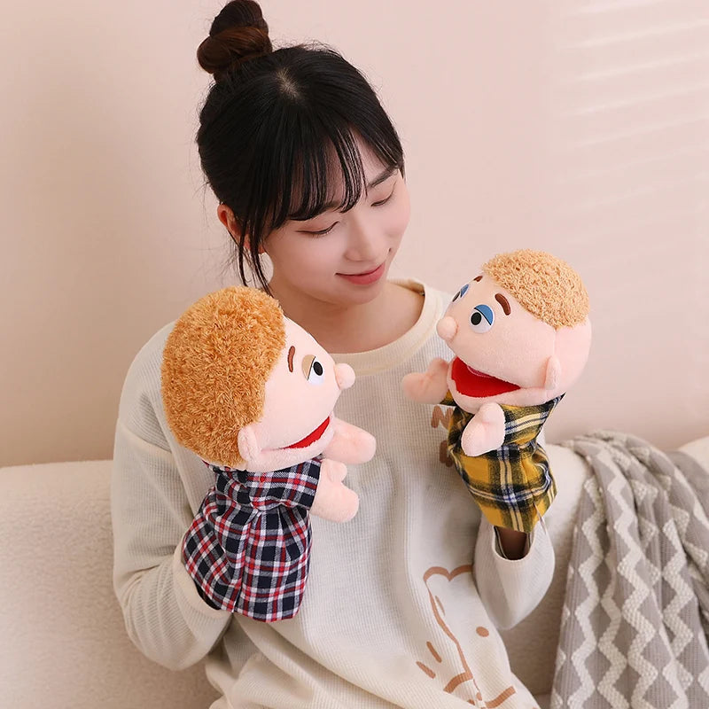 A woman is holding a soft plush hand puppet with light brown hair and a red nose, interacting with it.