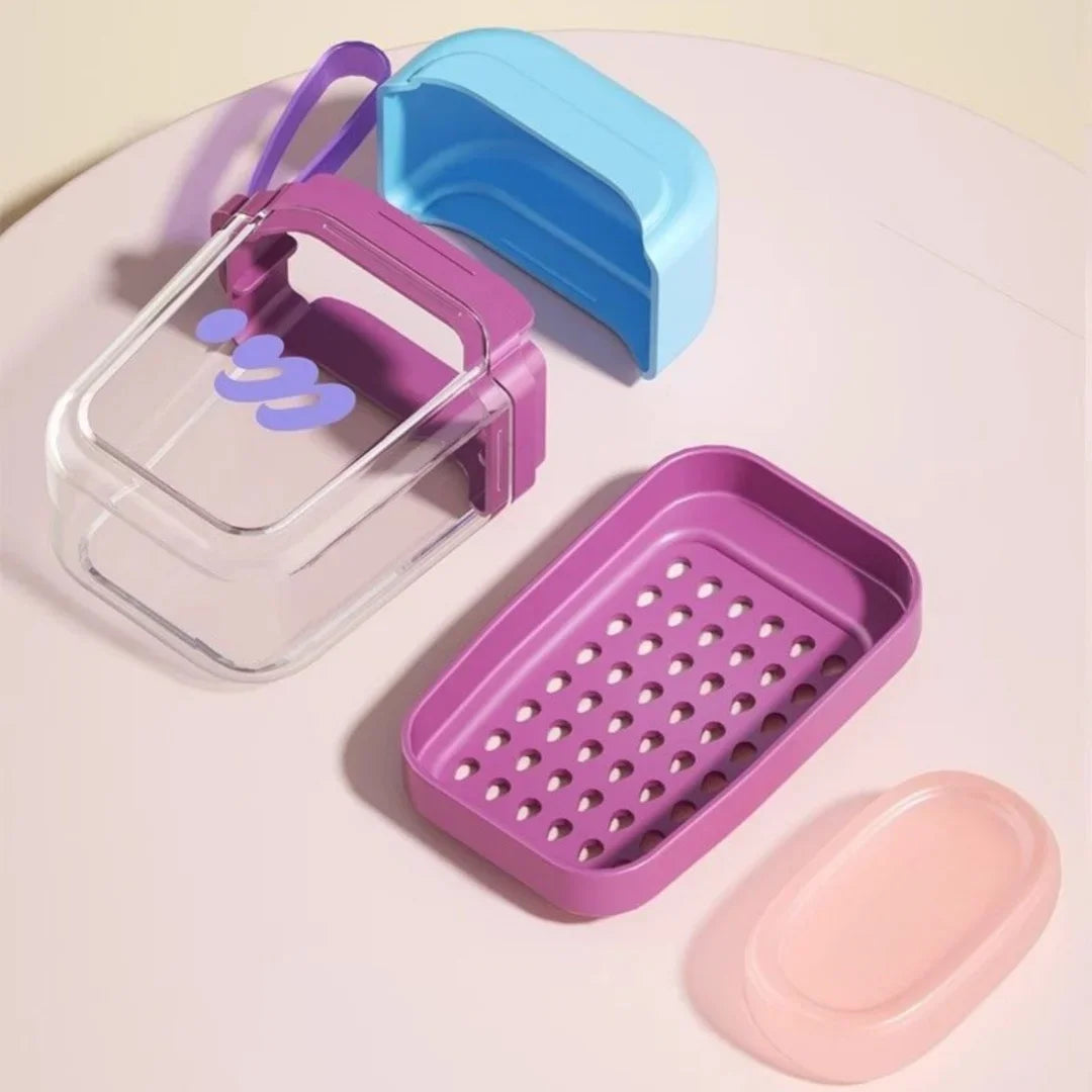 A set of pink and blue leakproof travel soap cases and a pink tray are displayed on a white surface.