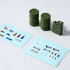 A set of green RC car decorative accessories including surfboard, kayak, and roadblocks.