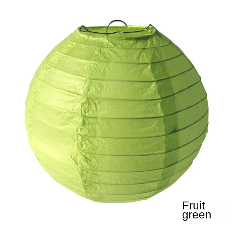 A lime green paper lantern shaped like a sphere, used for decoration.