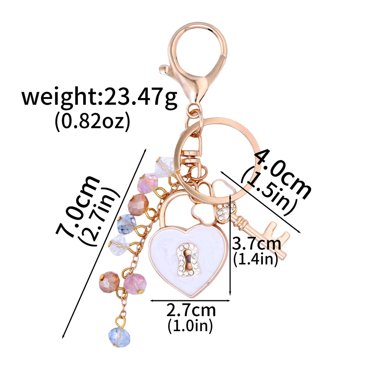 Gold-toned keychain featuring a bow, heart, and key charms with various colored rhinestones.
