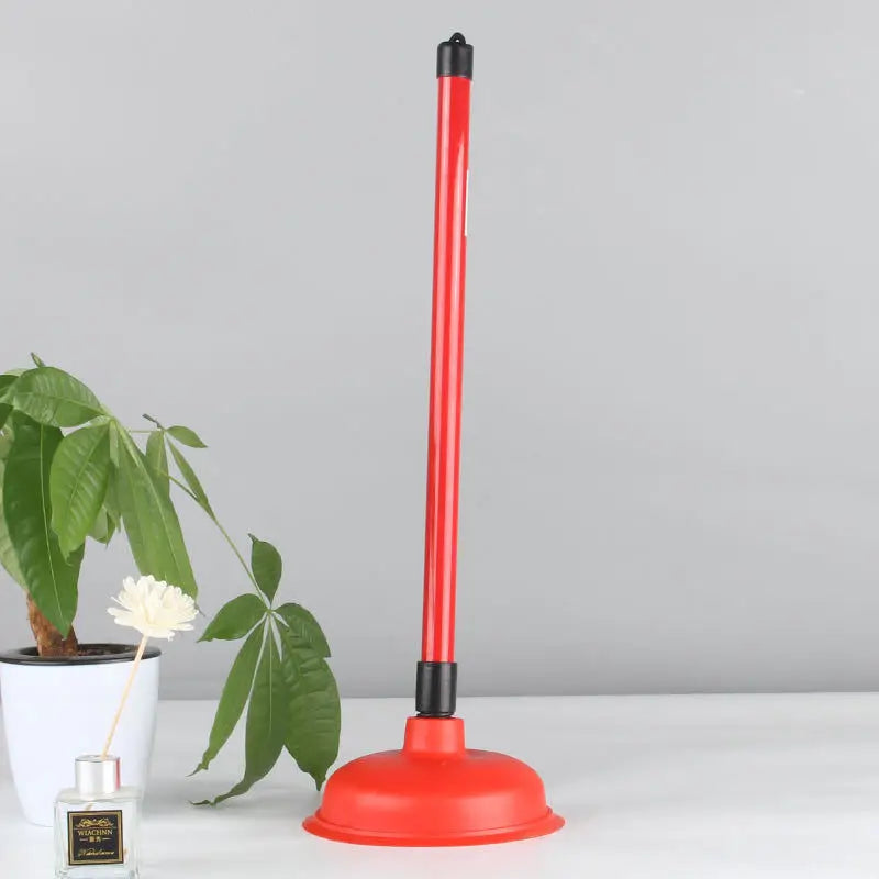 A red heavy-duty toilet and drain plunger with a black handle and wide base.