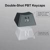 A close-up view of a black and white double-shot PBT keycap set featuring durable material and craft fonts.