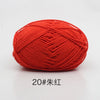 A ball of bright orange red yarn used for knitting and crochet projects.