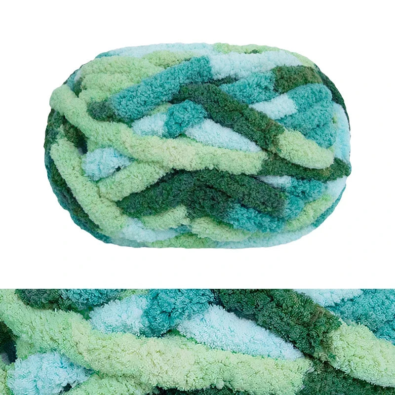 A ball of chunky chenille yarn in shades of green and blue.