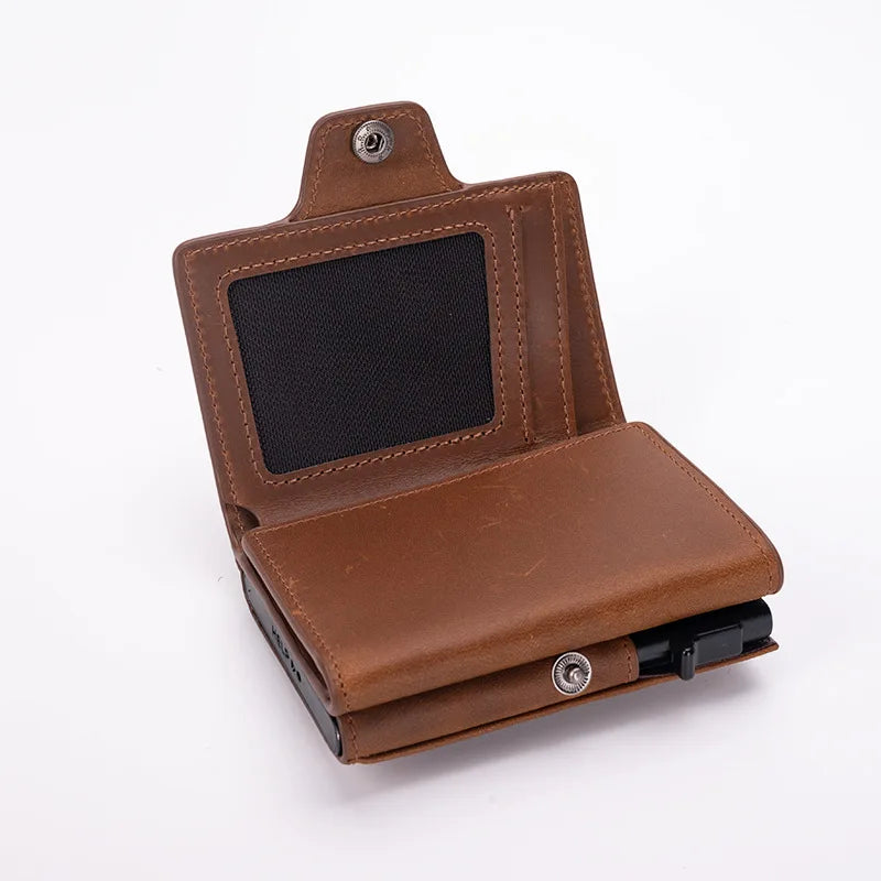 A brown leather pop-up card holder wallet with a black display window.