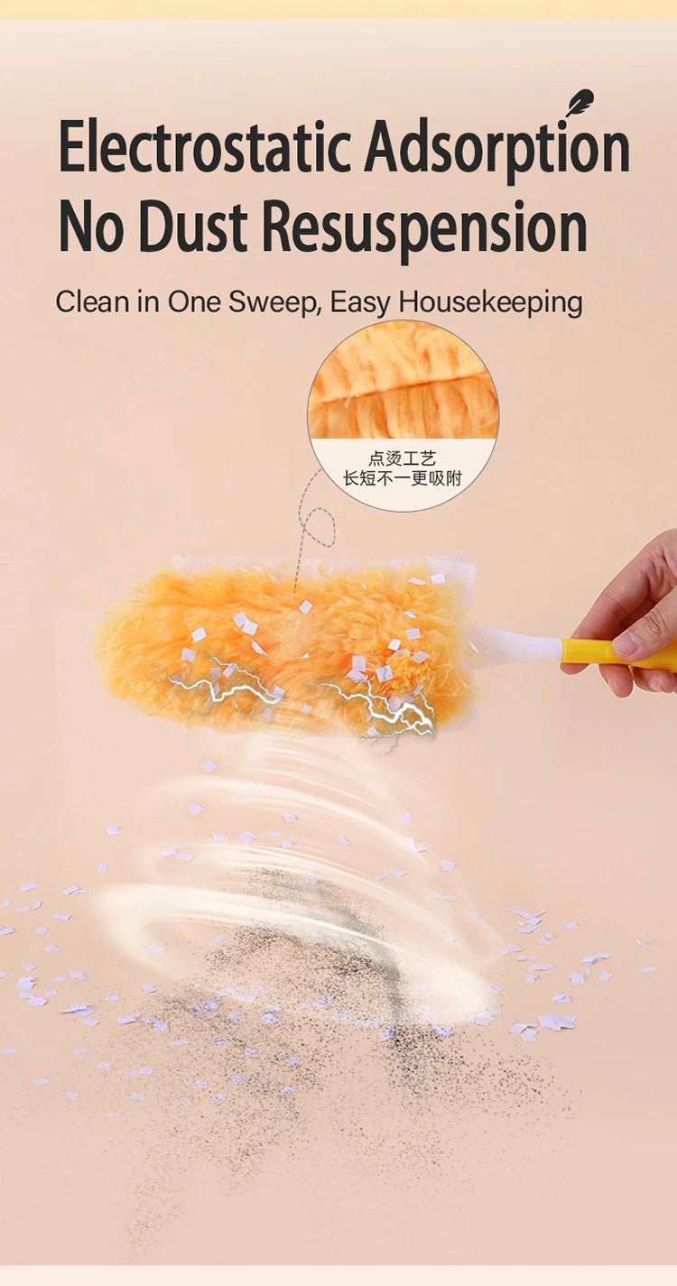 A hand is using a yellow electrostatic duster with orange fuzzy refills to clean dust from a surface.