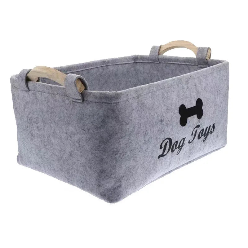 A gray felt storage basket with handles is shown, labeled Dog Toys.