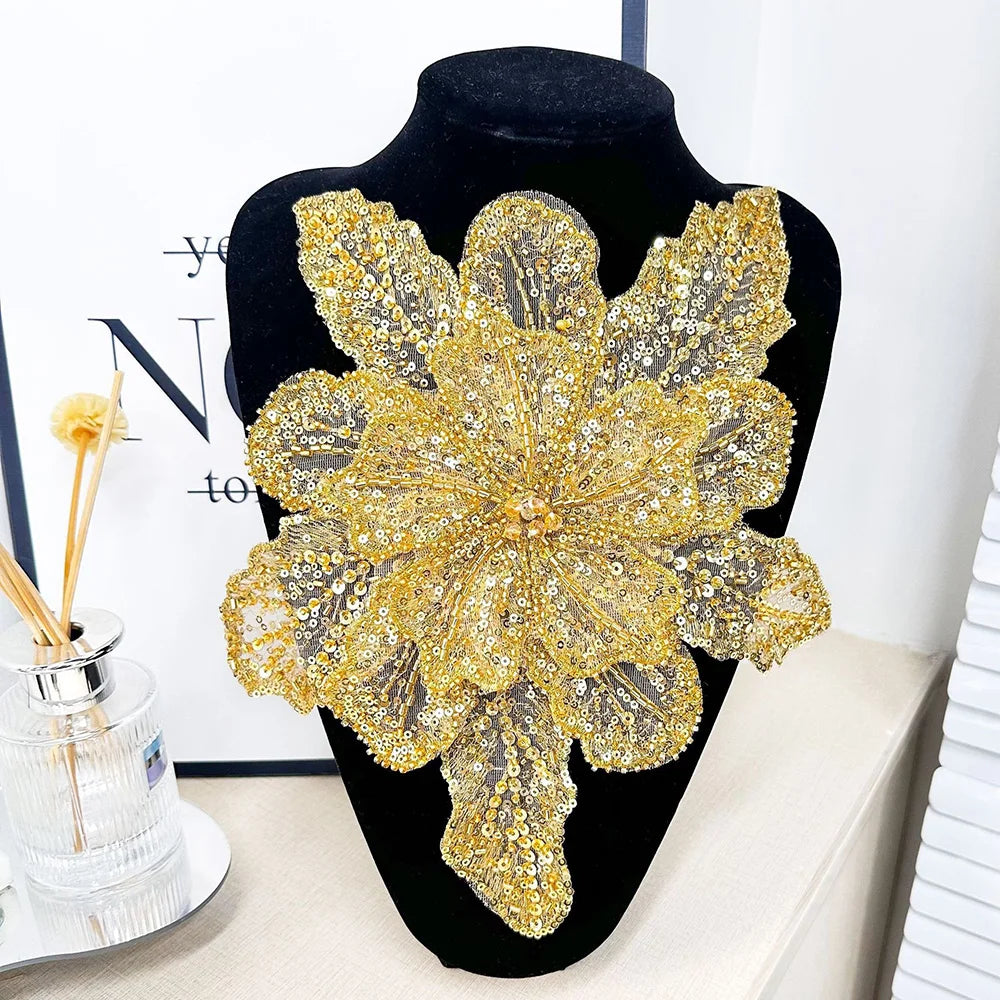 A large, intricate gold sequin floral lace applique patch for sewing and DIY crafts displayed on a black mannequin.