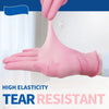 A hand wearing a pink disposable glove is shown, demonstrating high elasticity and tear resistance.