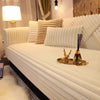 A white plush sofa cushion mat with vertical pleats is displayed on a light-colored sofa.