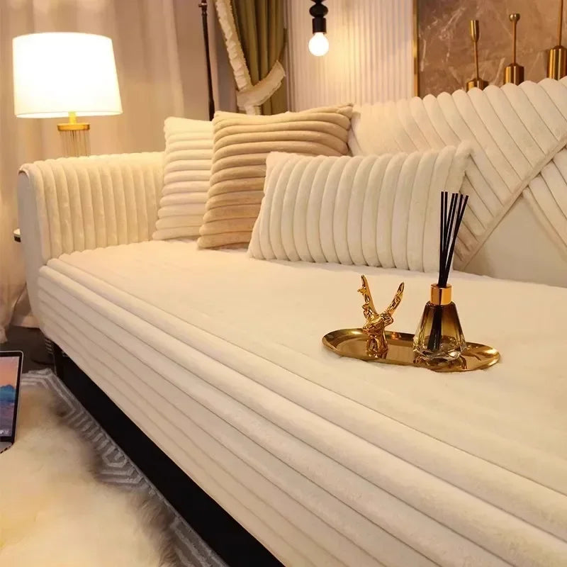 A white plush sofa cushion mat with vertical pleats is displayed on a light-colored sofa.