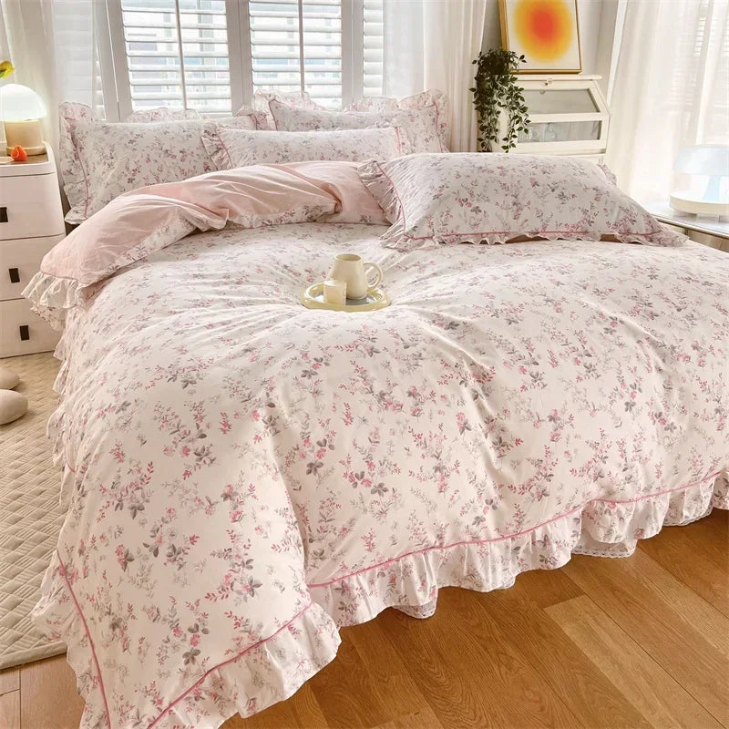 A floral ruffle cotton duvet cover set with pink and white floral patterns on a bed.