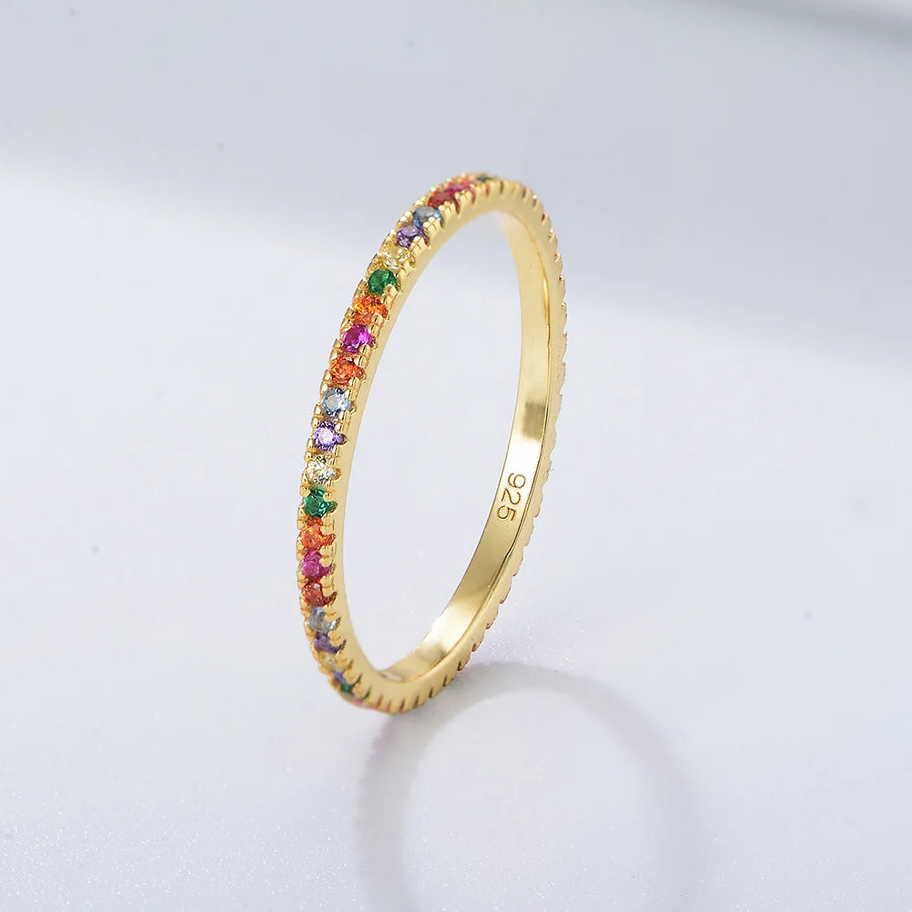 A gold-plated ring featuring a stack of colorful cubic zirconia stones.